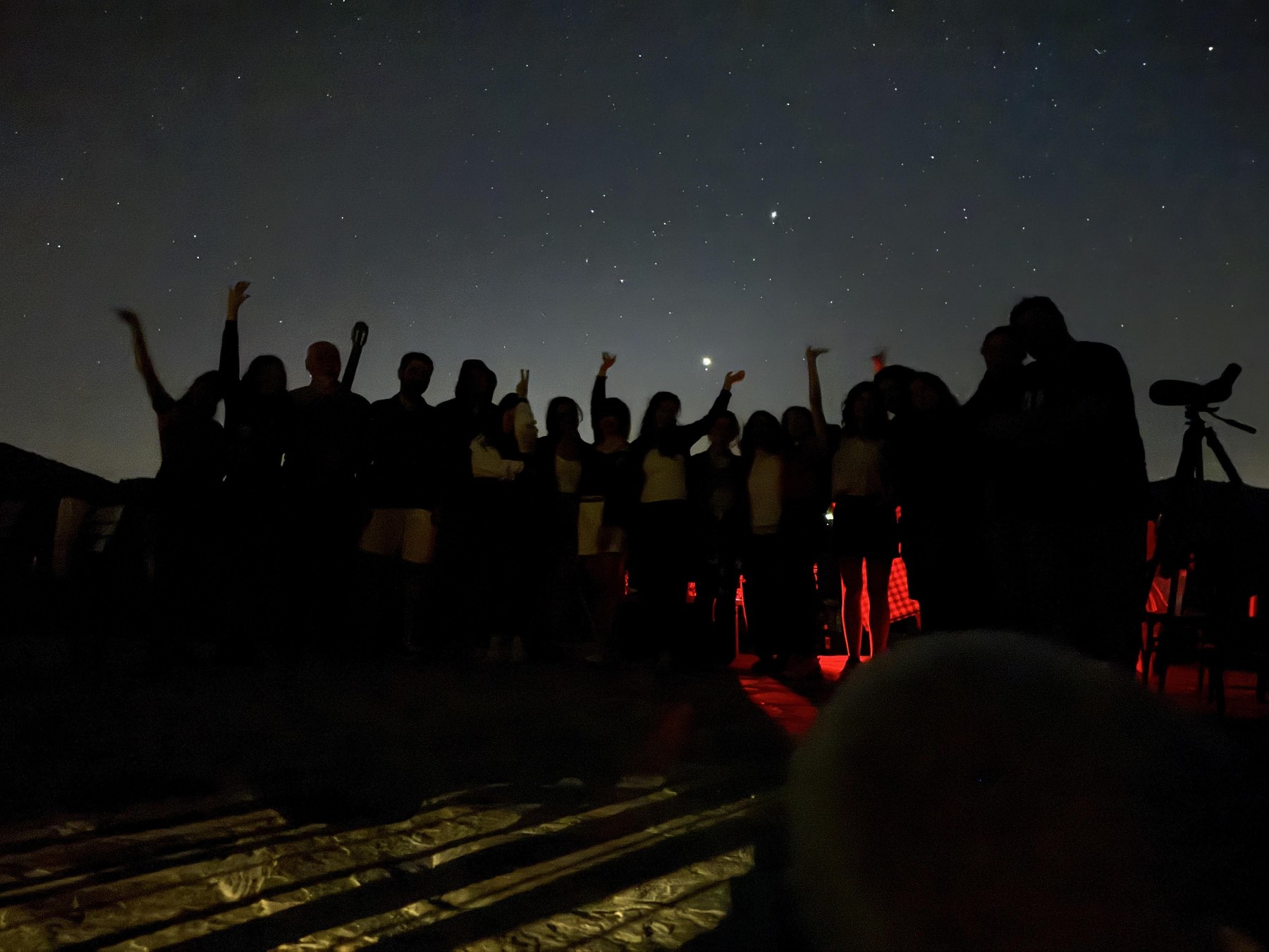 Camp participants gathered under the night sky