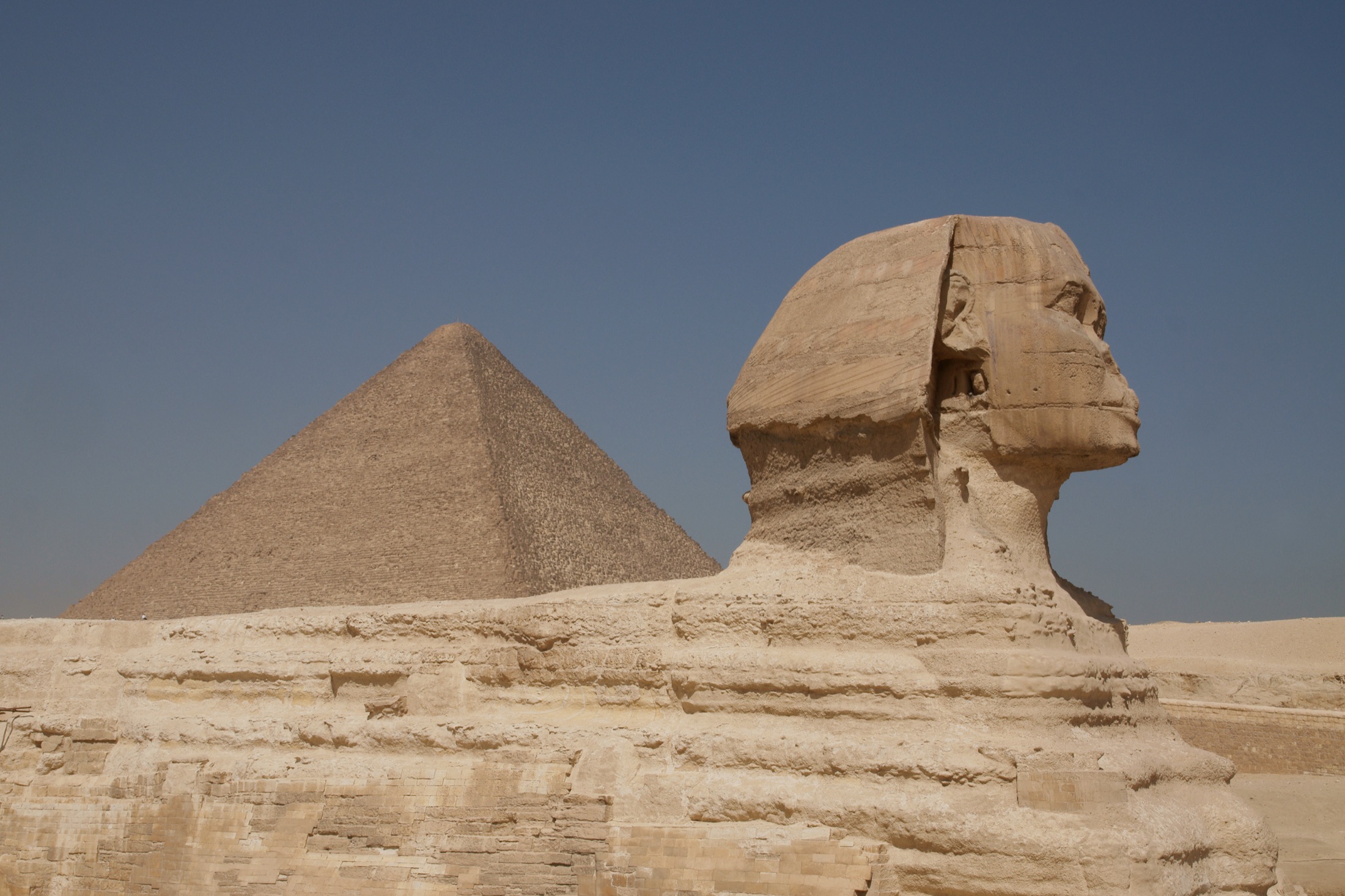 The Great Sphinx of Giza with a pyramid behind it